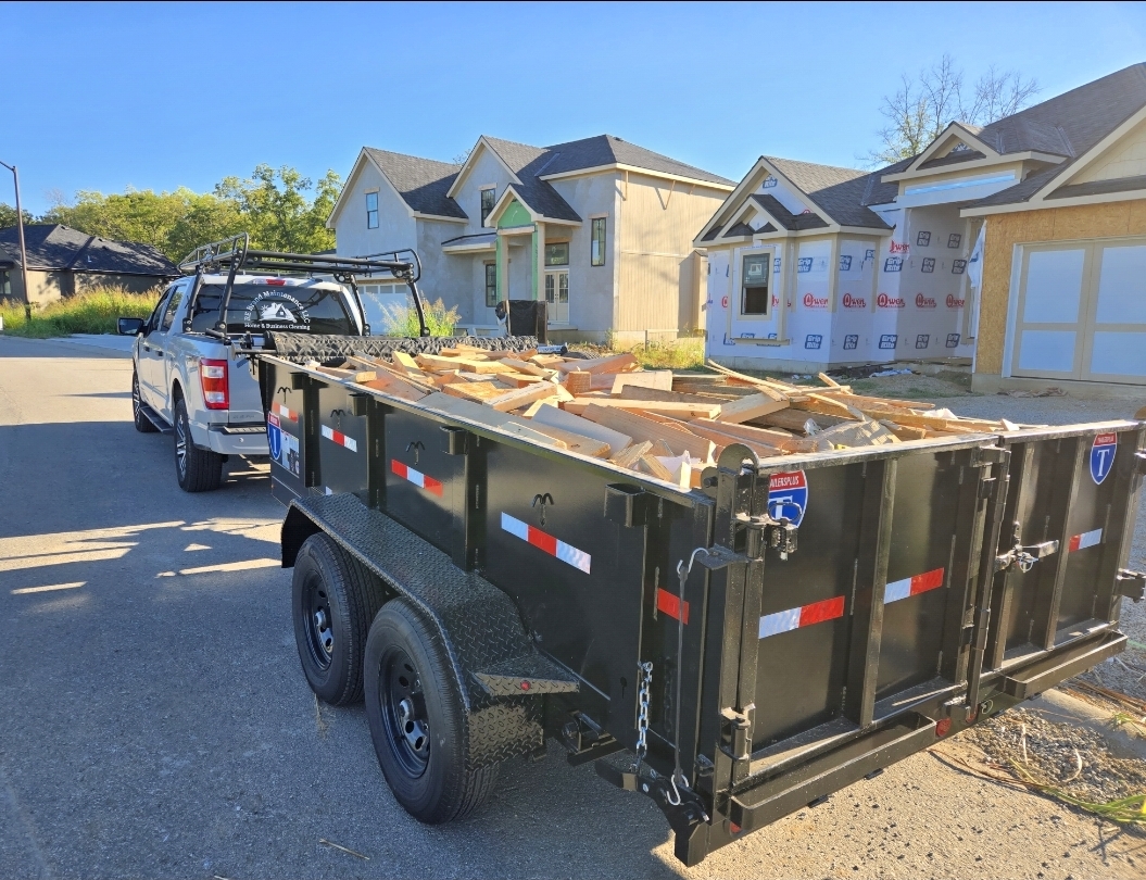 RE Brand Maintenance truck and trailer hauling construction debris